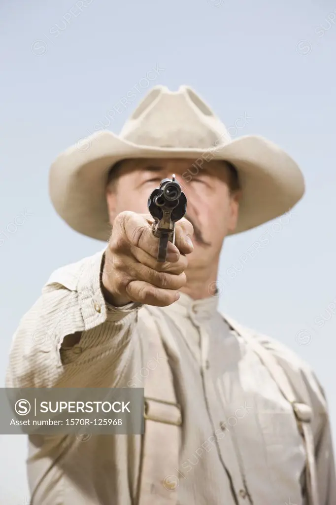 Close up of a cowboy aiming his gun