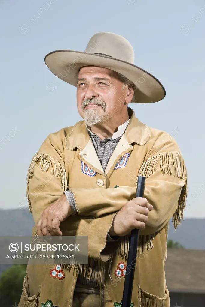 Portrait of a cowboy standing with his gun