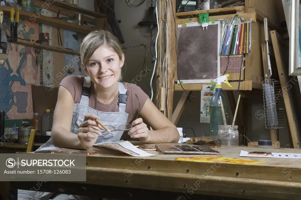 A young woman working in an art studio, portrait