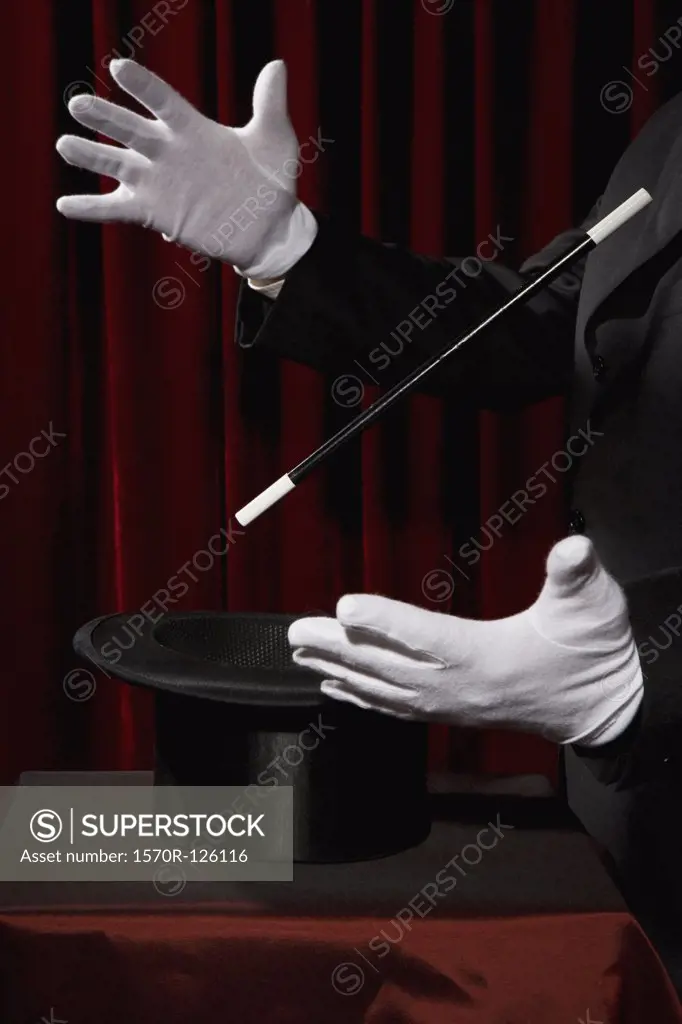 A magician's gloved hands performing a magic trick