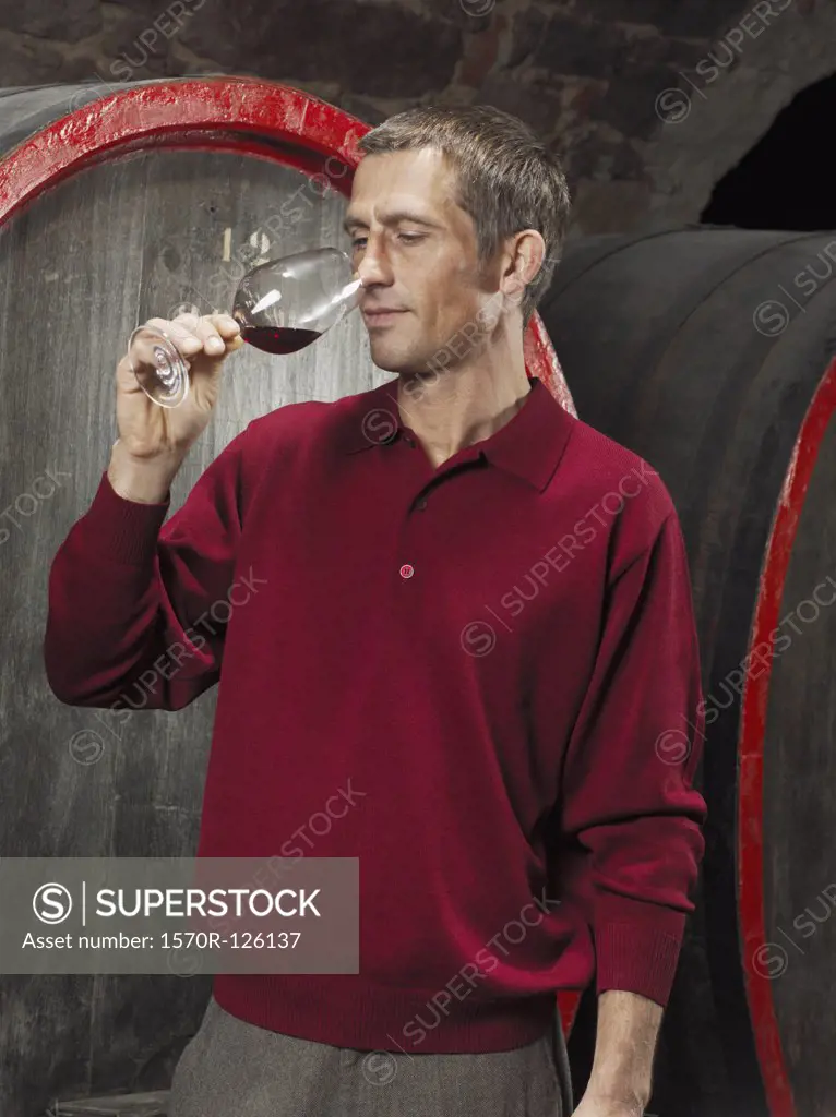 A vintner tasting a red wine