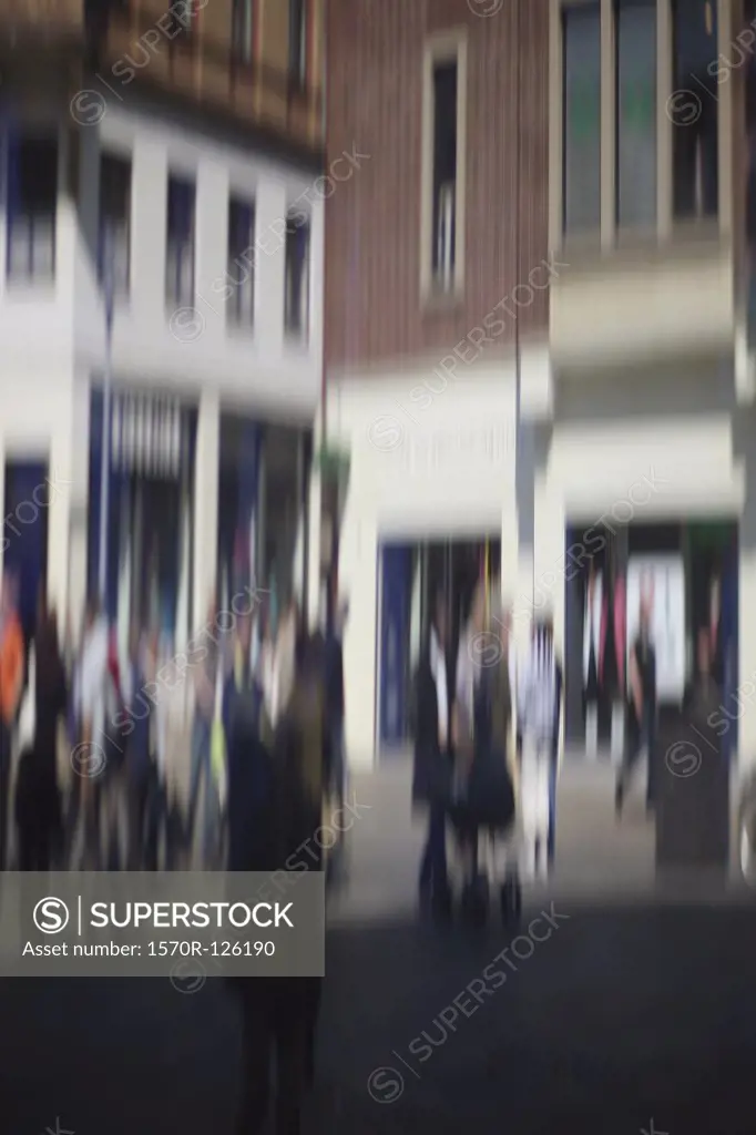 Defocused street scene with people walking