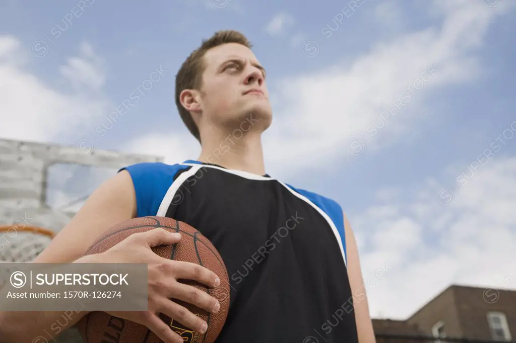 A basketball player holding a ball, portrait