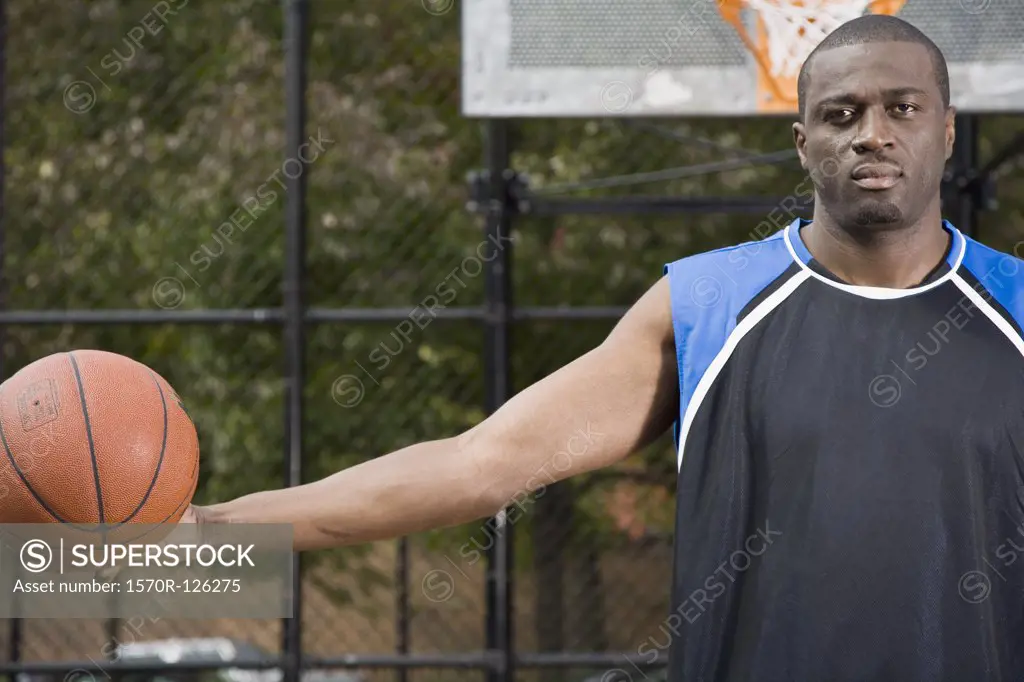 A basketball player holding a ball, portrait