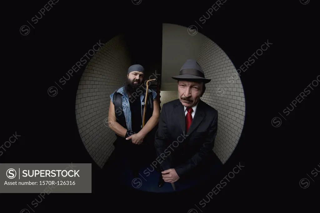 An organized crime boss with his bodyguard, viewed through a peephole