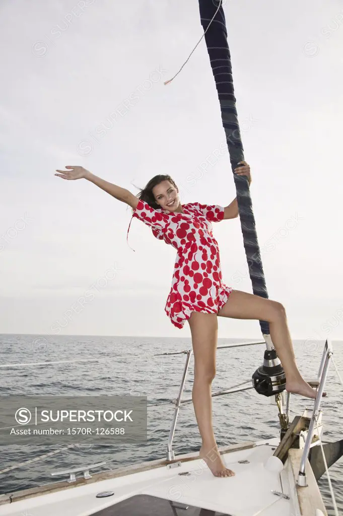 A woman standing on a yacht and waving