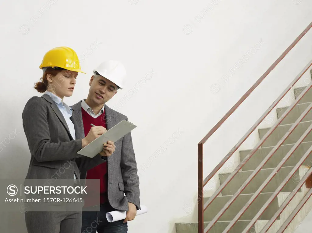 Two architects working on a construction site