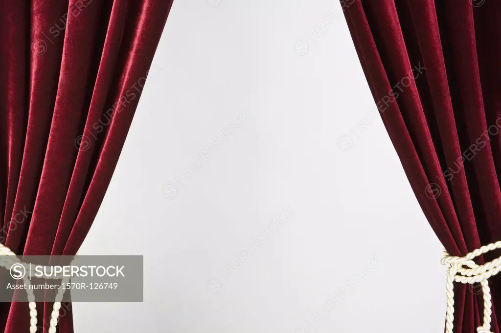 Red velvet curtains tied with gold rope