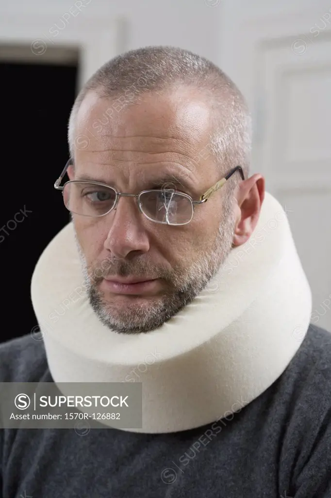 A man wearing a neck brace and cracked glasses