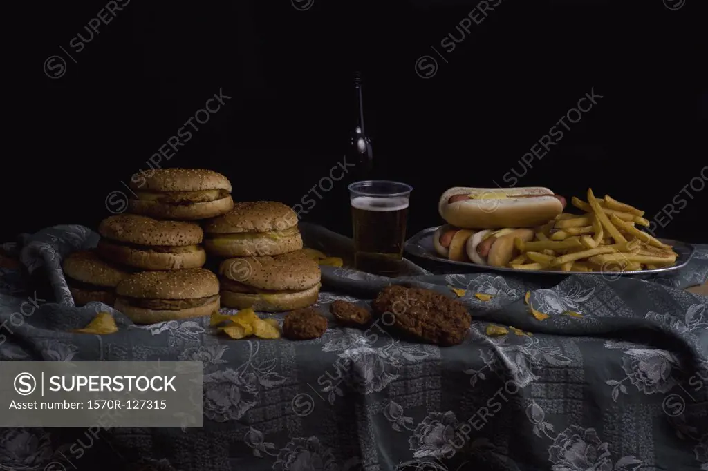 Variety of fast food and beer bottle, still life