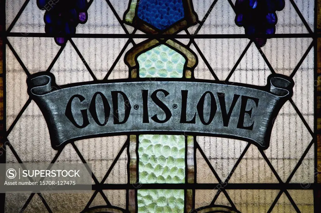 God Is Love written in a stained glass window