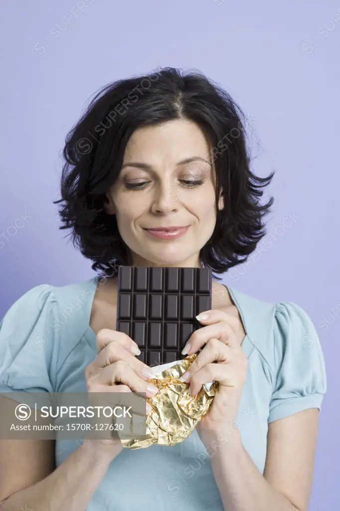 A woman holding a chocolate bar, 
