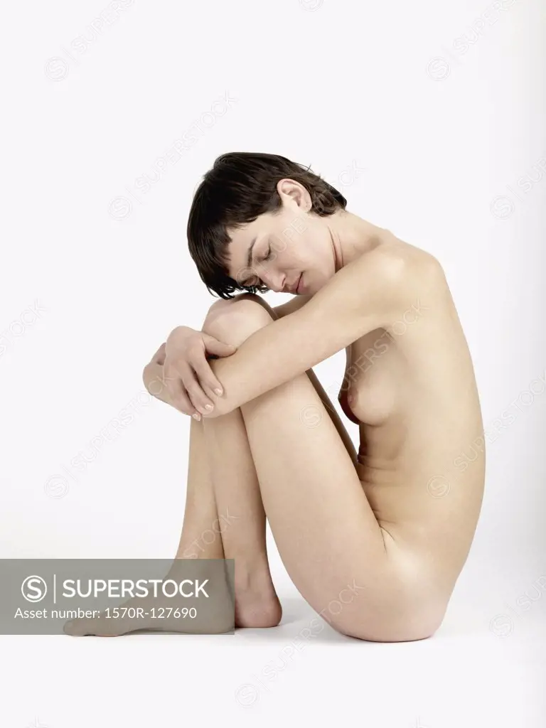Side view of a naked woman sitting