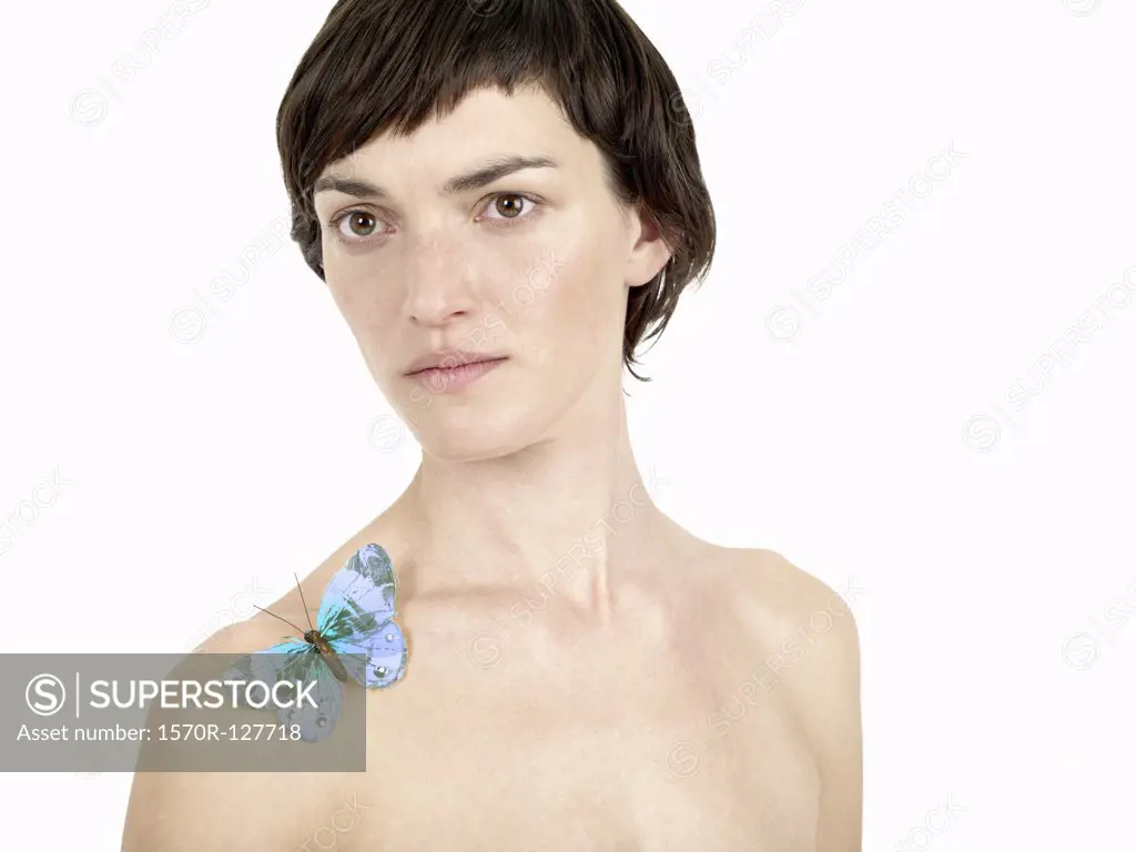 A woman with a butterfly on her shoulder
