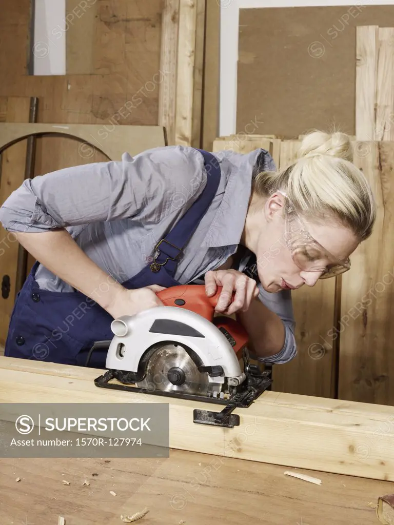 A woman sawing wood