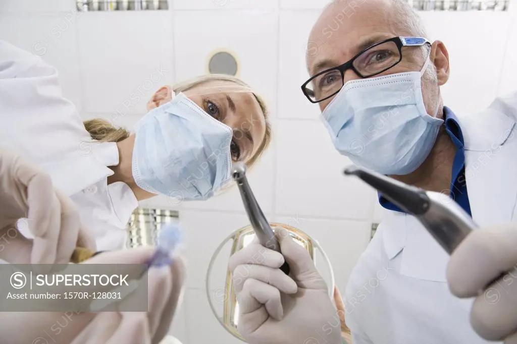 View from below of a dentist and an assistant holding 