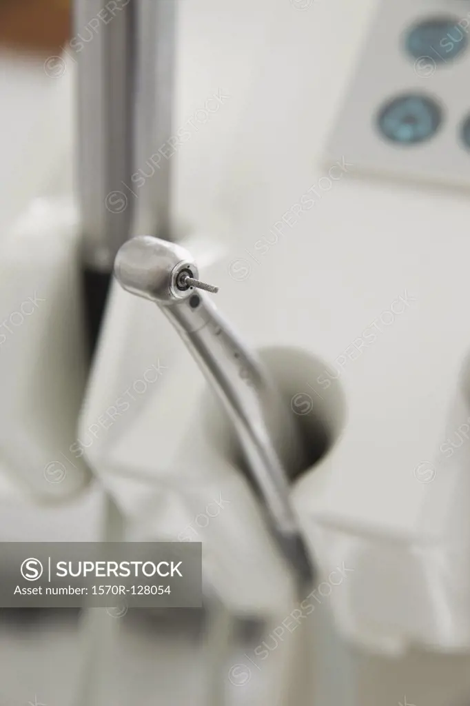A dental drill docked in a dental examination room