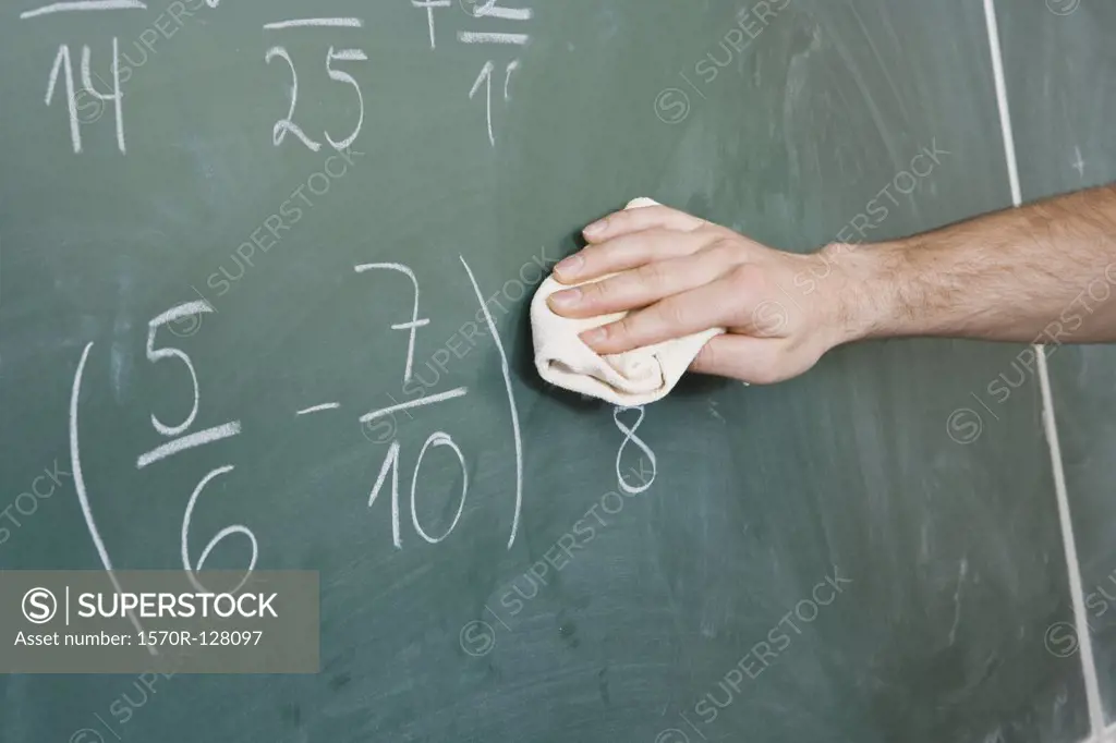 Detail of a man dusting a blackboard