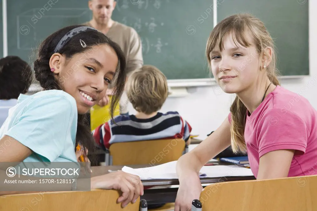Two schoolgirls sitting in a classroom