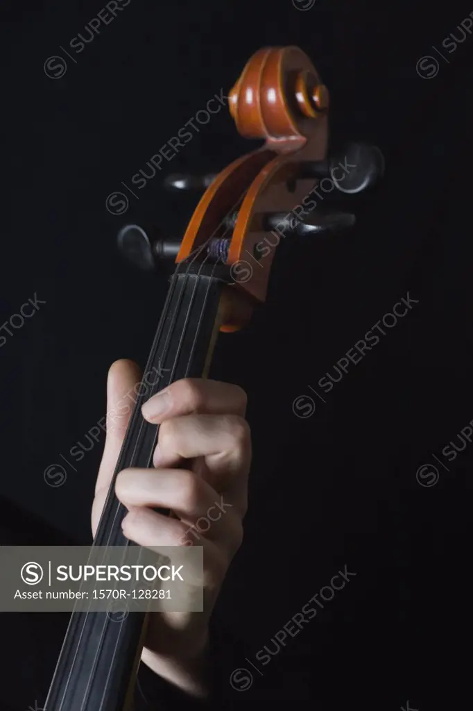Human hand playing a cello