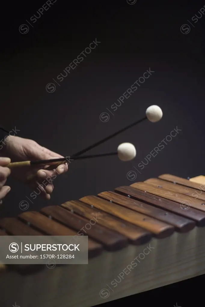 Human hands playing a xylophone