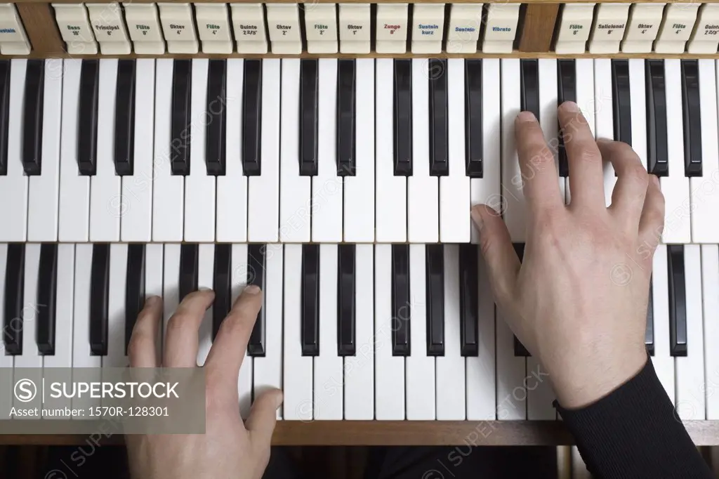 Human hands playing a organ