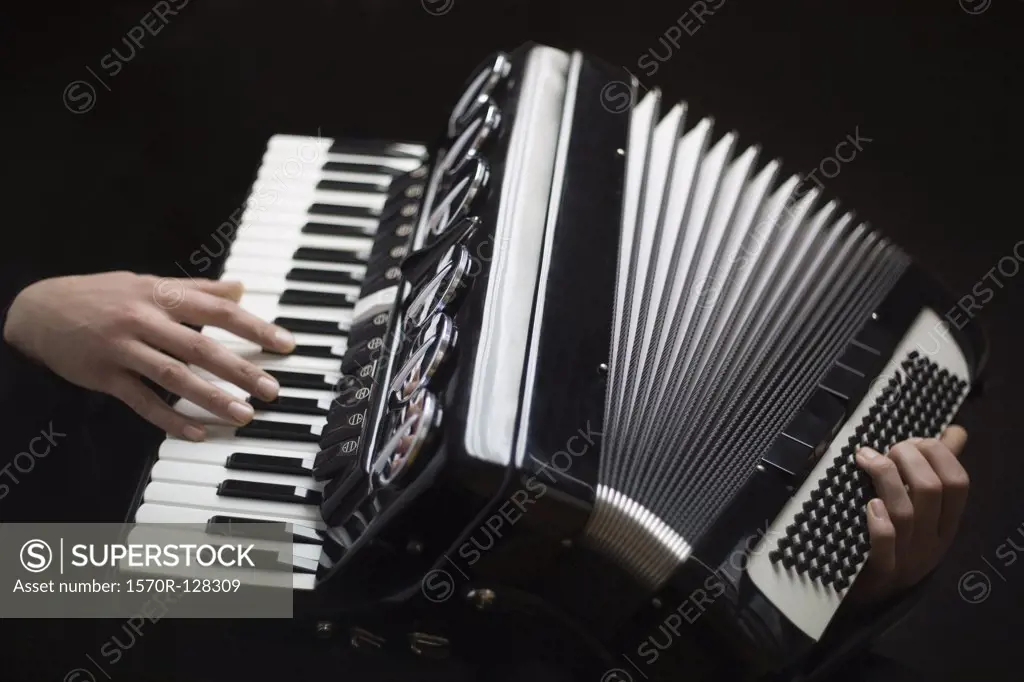 Human hands playing an accordion