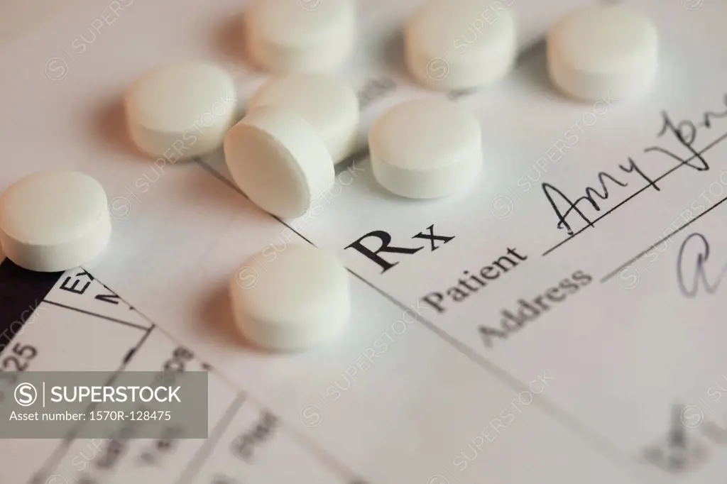 Pills scattered across a prescription