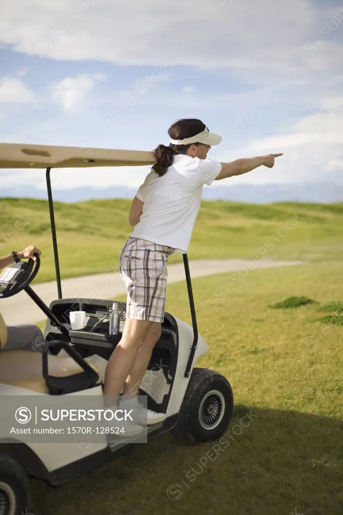 A golfer pointing from a golf cart, Palm Springs, California, USA