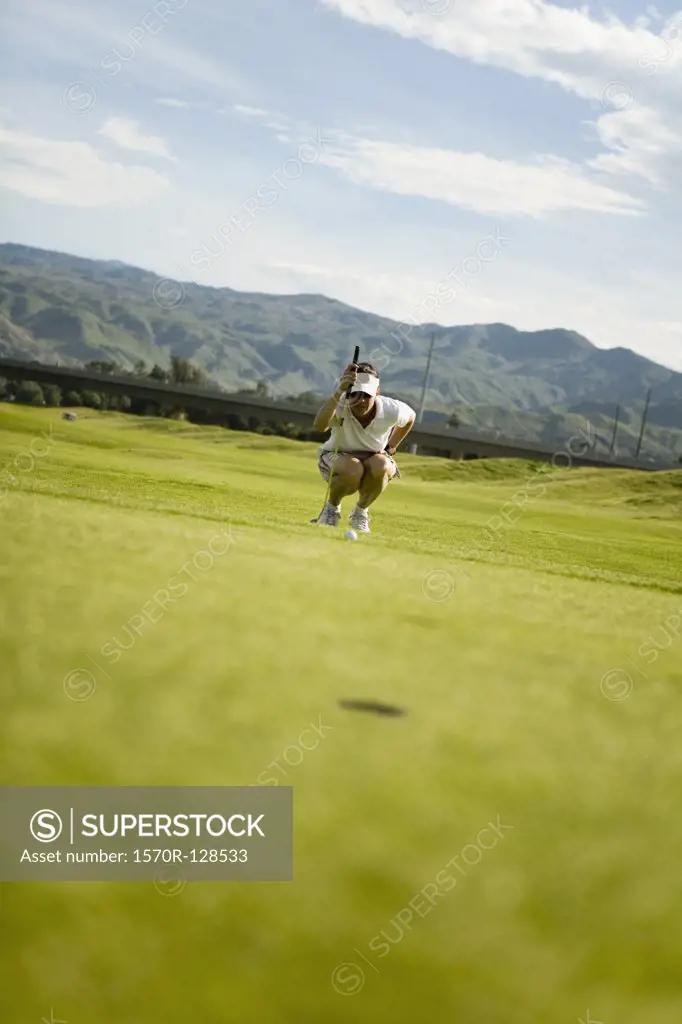 A golfer lining up a shot, Palm Springs, California, USA