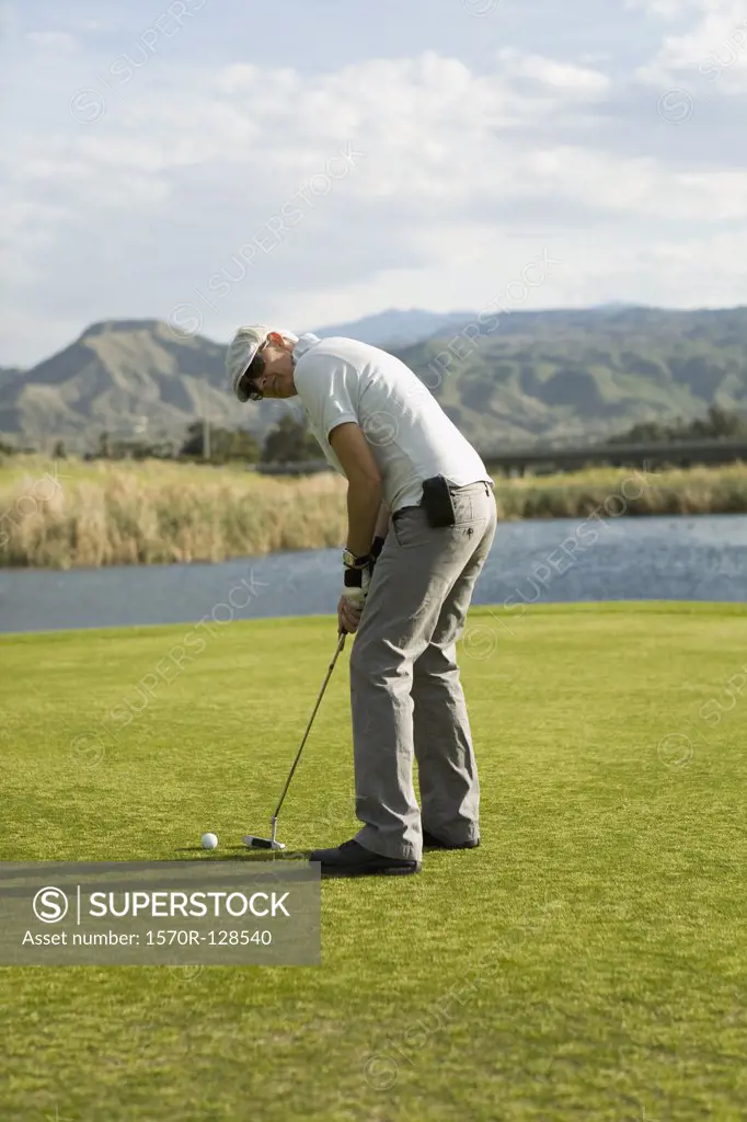 A golfer putting, Palm Springs, California, USA