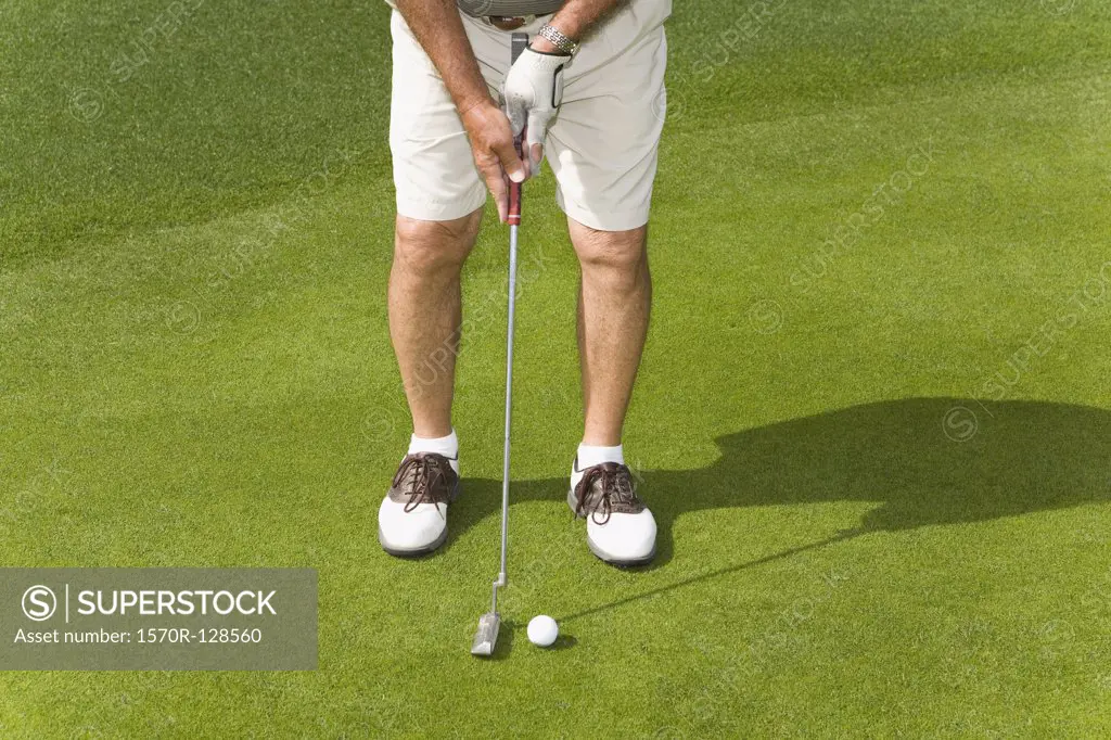 Detail of a golfer putting