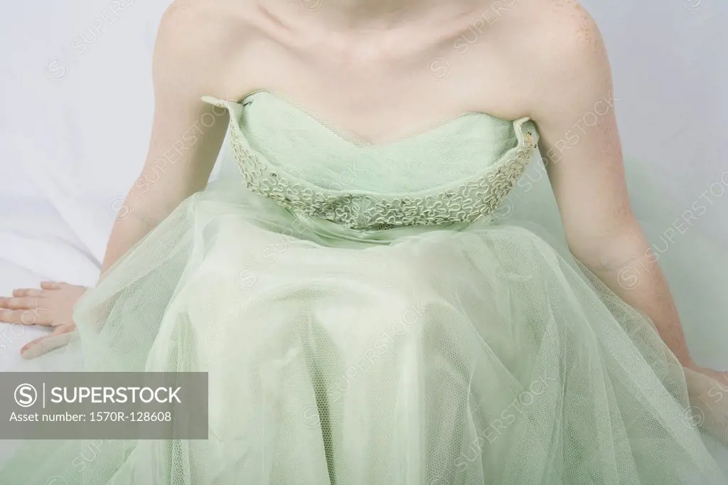 A young woman wearing a strapless vintage dress