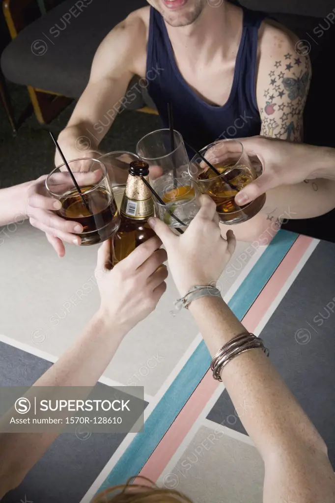 A group of friends toasting drinks at a bar