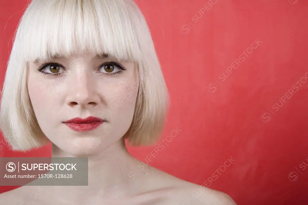 A portrait of a young woman with a blonde bob