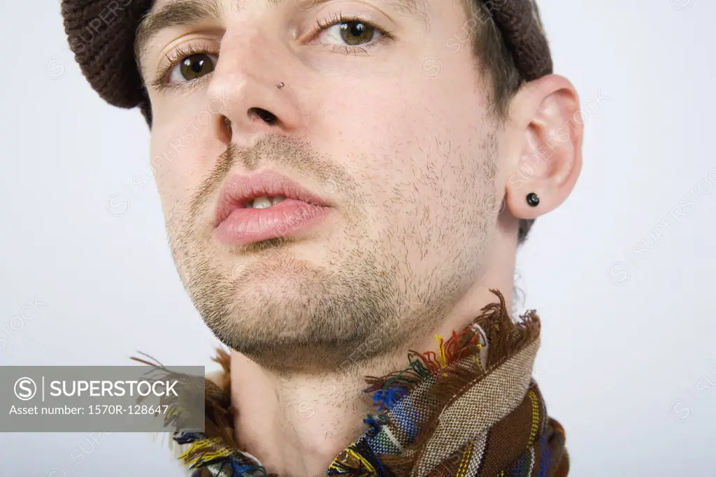 A portrait of a man wearing a hat and scarf