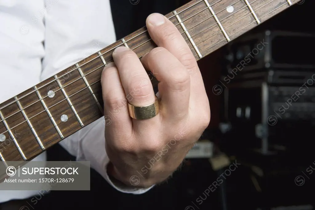 Detail of a man playing an electric guitar
