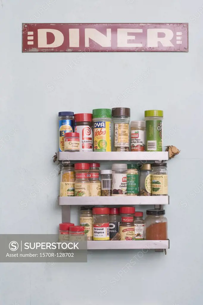 Vintage 'diner' sign on a wall above a spice rack