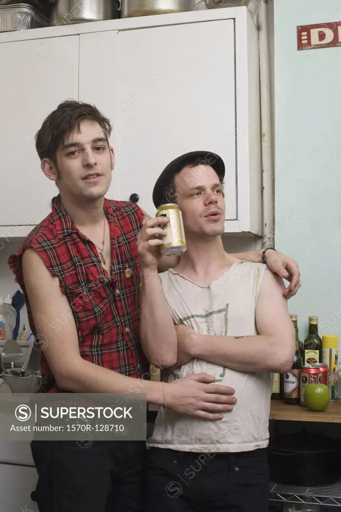 A young couple standing together in a kitchen