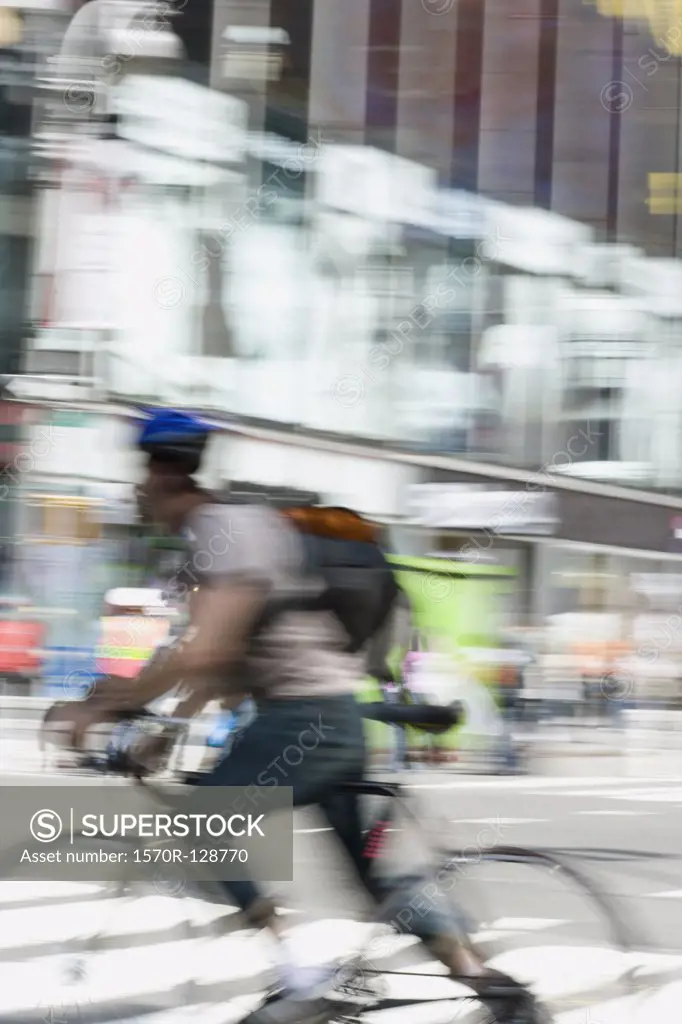 A cyclist on a city street, Manhattan, New York City