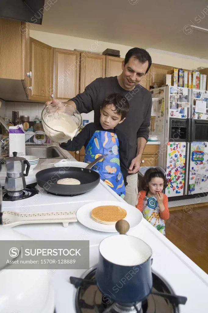 A father and his children making pancakes together
