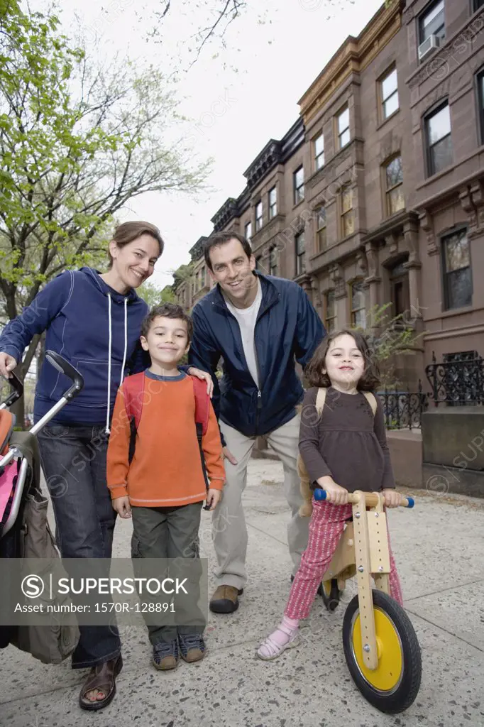 A family standing together on a sidewalk, Brooklyn, New York City