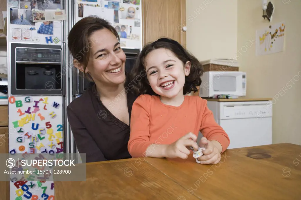 Portrait of a mother and daughter sitting at a kitchen table