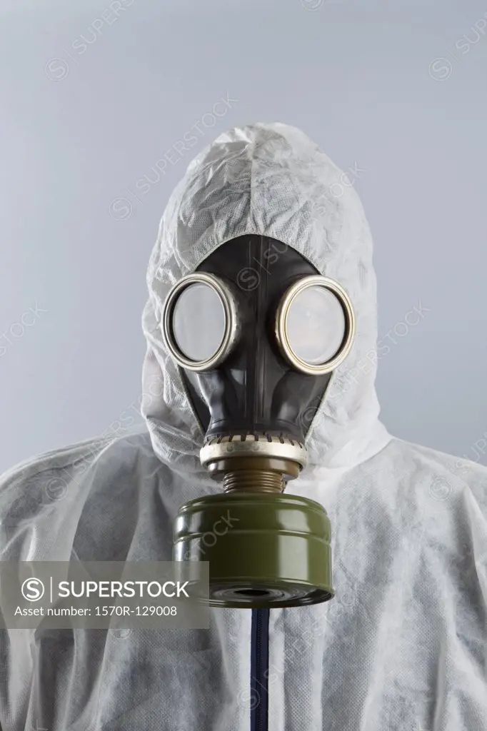 A man wearing a gas mask and protective suit