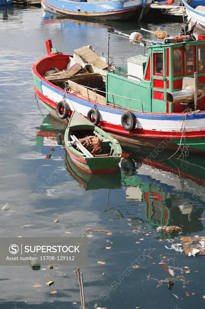 A rowboat tied to a tugboat, Setubal, Portugal