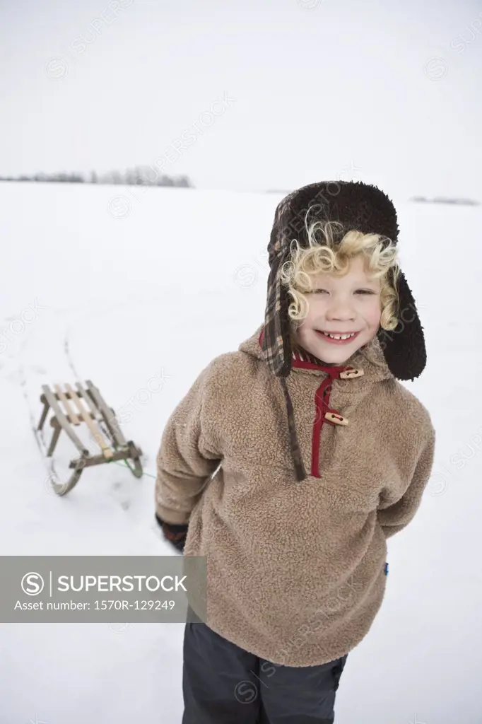 A boy pulling a sled