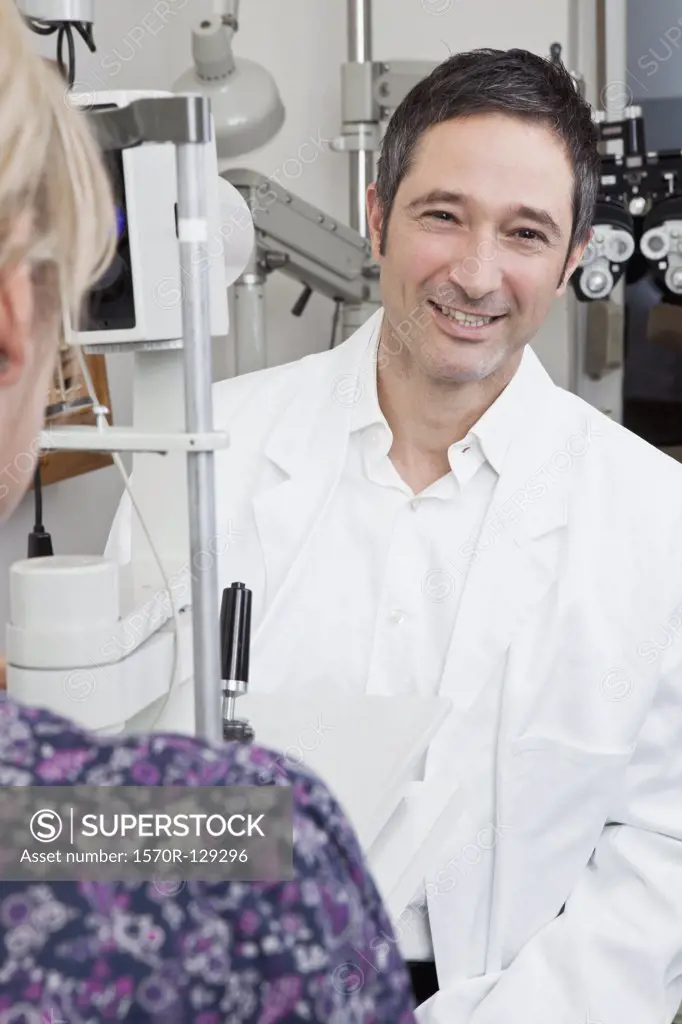 An ophthalmologist using a slit-lamp biomicroscope to examine a patient