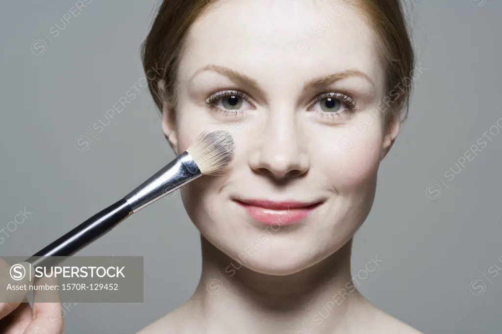 A make-up artist applying blush