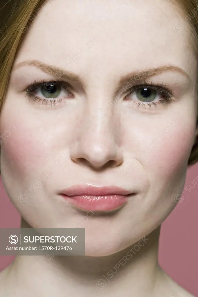 A woman grimacing in irritation, extreme close up