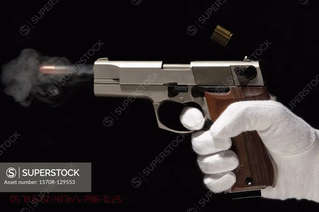 A Gloved Hand Firing A Gun